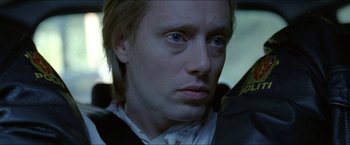 Movie still from “Headhunters” (2011), directed by Morten Tyldum – A person with long hair; Close Up shot, Over the shoulder angle