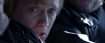 Movie still from “Headhunters” (2011), directed by Morten Tyldum – A person's face with blue eyes; Close Up shot, Over the shoulder angle