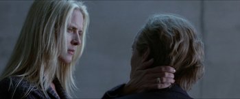 Movie still from “Headhunters” (2011), directed by Morten Tyldum – Two people are looking at each other in a dark room; Close Up shot, Over the shoulder angle