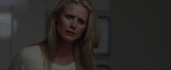 Movie still from “Headhunters” (2011), directed by Morten Tyldum – A woman with long blonde hair is looking at the camera; Close Up shot, Over the shoulder angle