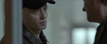 Movie still from “Headhunters” (2011), directed by Morten Tyldum – A person wearing a hat; Close Up shot, Over the shoulder angle