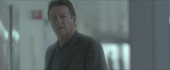 Movie still from “Headhunters” (2011), directed by Morten Tyldum – A person wearing a suit and tie; Close Up shot, Low angle