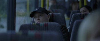Movie still from “Headhunters” (2011), directed by Morten Tyldum – A man sitting on a bus looking out the window; Close Up shot, High angle