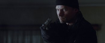 Movie still from “Headhunters” (2011), directed by Morten Tyldum – A person holding a gun; Close Up shot, Low angle