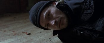 Movie still from “Headhunters” (2011), directed by Morten Tyldum – A person wearing a hat; Close Up shot, Overhead angle
