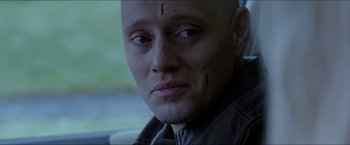 Movie still from “Headhunters” (2011), directed by Morten Tyldum – A man with a scar on his head and forehead; Close Up shot, Over the shoulder angle