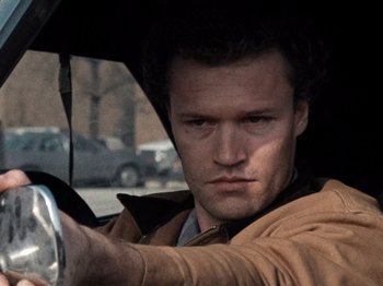 Movie still from “Henry: Portrait of a Serial Killer” (1986), directed by John McNaughton – A person holding an open umbrella; Close Up shot, Low angle