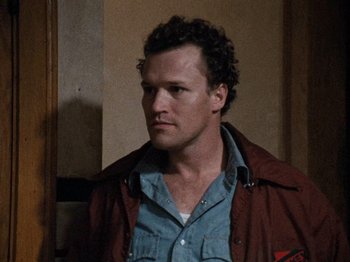 Movie still from “Henry: Portrait of a Serial Killer” (1986), directed by John McNaughton – A person wearing a shirt and a jacket; Close Up shot, Low angle