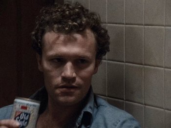 Movie still from “Henry: Portrait of a Serial Killer” (1986), directed by John McNaughton – A person with curly hair; Close Up shot, Low angle