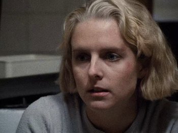 Movie still from “Henry: Portrait of a Serial Killer” (1986), directed by John McNaughton – A person with blonde hair; Close Up shot, Over the shoulder angle