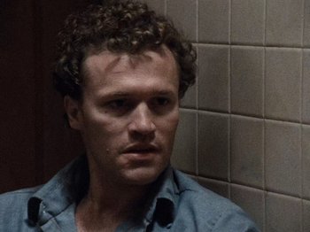 Movie still from “Henry: Portrait of a Serial Killer” (1986), directed by John McNaughton – A person with curly hair; Close Up shot, High angle