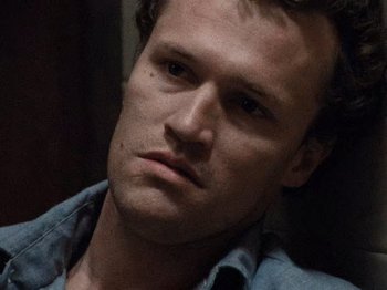 Movie still from “Henry: Portrait of a Serial Killer” (1986), directed by John McNaughton – A person wearing a blue shirt; Close Up shot, High angle
