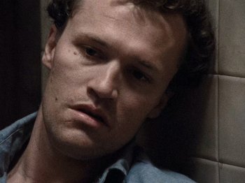 Movie still from “Henry: Portrait of a Serial Killer” (1986), directed by John McNaughton – A person laying on the ground; Close Up shot, Overhead angle