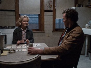 Movie still from “Henry: Portrait of a Serial Killer” (1986), directed by John McNaughton – A man and a woman sitting at a table; Medium shot, Over the shoulder angle