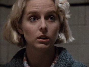 Movie still from “Henry: Portrait of a Serial Killer” (1986), directed by John McNaughton – A person with short blonde hair; Close Up shot, Over the shoulder angle