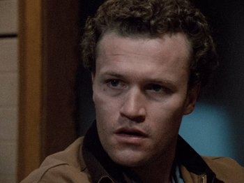 Movie still from “Henry: Portrait of a Serial Killer” (1986), directed by John McNaughton – A person with curly hair; Close Up shot, High angle