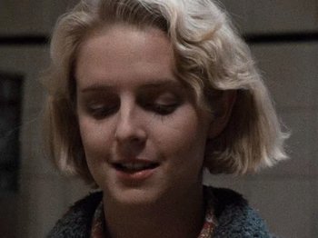 Movie still from “Henry: Portrait of a Serial Killer” (1986), directed by John McNaughton – A woman with blonde hair is looking to her left; Close Up shot, Low angle