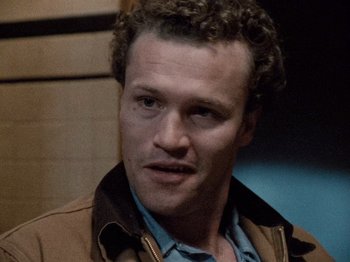 Movie still from “Henry: Portrait of a Serial Killer” (1986), directed by John McNaughton – A person with curly hair; Close Up shot, High angle