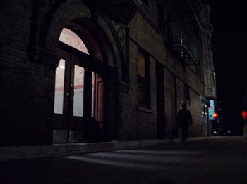 Movie still from “Henry: Portrait of a Serial Killer” (1986), directed by John McNaughton – A person walking down a street at night; Extreme Wide shot, High angle