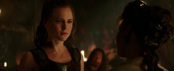 Movie still from “Hercules” (2014), directed by Brett Ratner – A woman standing next to a man in front of a crowd; Close Up shot, Over the shoulder angle
