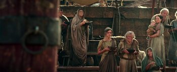 Movie still from “Hercules” (2014), directed by Brett Ratner – A woman dressed in roman clothing and holding a bowl of food; Medium shot, Low angle