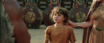 Movie still from “Hercules” (2014), directed by Brett Ratner – A young boy is standing in front of a group of soldiers; Close Up shot, Over the shoulder angle