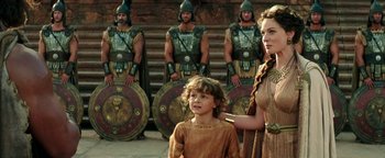 Movie still from “Hercules” (2014), directed by Brett Ratner – Two women and a child in front of a group of soldiers; Medium shot, Over the shoulder angle