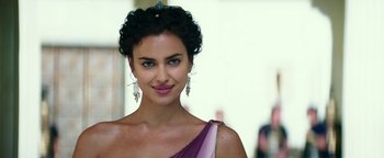 A beautiful woman with blue eyes wearing a purple dress