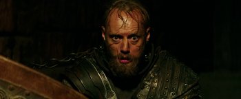 Movie still from “Hercules” (2014), directed by Brett Ratner – A person with a beard wearing armor; Close Up shot, Low angle