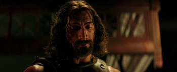 Movie still from “Hercules” (2014), directed by Brett Ratner – A person with a beard wearing a costume; Close Up shot, Over the shoulder angle