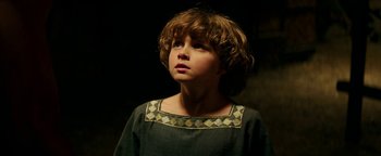 Movie still from “Hercules” (2014), directed by Brett Ratner – A young boy in a medieval dress looking up at the sky; Close Up shot, High angle