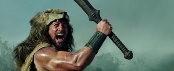 Movie still from “Hercules” (2014), directed by Brett Ratner – A person holding a sword; Medium shot, Low angle