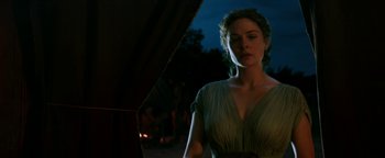 Movie still from “Hercules” (2014), directed by Brett Ratner – A beautiful woman standing in front of a fire pit; Medium shot, Over the shoulder angle