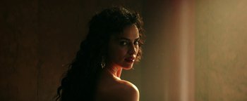 Movie still from “Hercules” (2014), directed by Brett Ratner – A beautiful woman with long curly hair posing for a picture; Close Up shot, Low angle