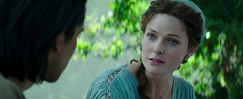 Movie still from “Hercules” (2014), directed by Brett Ratner – A person sitting on the ground near a tree; Close Up shot, Over the shoulder angle