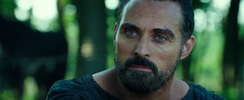 Movie still from “Hercules” (2014), directed by Brett Ratner – A person with a beard looking at the camera; Close Up shot, Over the shoulder angle
