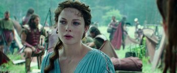 Movie still from “Hercules” (2014), directed by Brett Ratner – A woman in a blue dress looking at the camera; Close Up shot, Over the shoulder angle