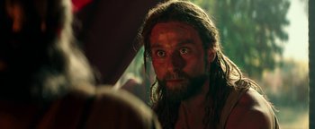 Movie still from “Hercules” (2014), directed by Brett Ratner – A person with long hair and a beard; Close Up shot, Over the shoulder angle
