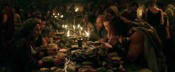 Movie still from “Hercules” (2014), directed by Brett Ratner – A group of people sitting around a table with candles; Medium shot, High angle