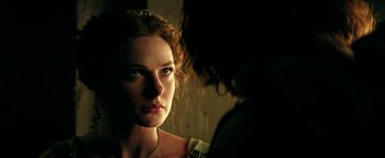 Movie still from “Hercules” (2014), directed by Brett Ratner – A young woman looking into a mirror while standing next to another woman; Close Up shot, Over the shoulder angle