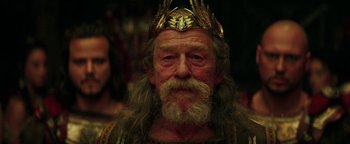 Movie still from “Hercules” (2014), directed by Brett Ratner – An old man with a beard wearing a crown; Close Up shot, Low angle