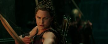 Movie still from “Hercules” (2014), directed by Brett Ratner – A person holding a bow and arrow; Close Up shot, Over the shoulder angle
