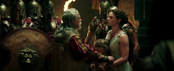 Movie still from “Hercules” (2014), directed by Brett Ratner – A group of people standing next to each other in a room; Medium shot, Over the shoulder angle