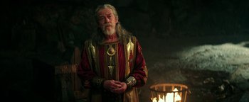 Movie still from “Hercules” (2014), directed by Brett Ratner – An old man with long grey hair and a long beard; Medium shot, Over the shoulder angle