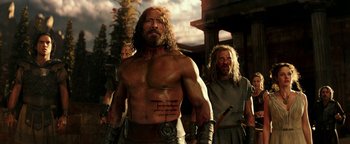 Movie still from “Hercules” (2014), directed by Brett Ratner – A man with long hair is standing next to another man with long hair; Medium shot, Low angle