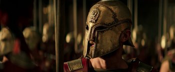Movie still from “Hercules” (2014), directed by Brett Ratner – A person wearing a golden helmet; Close Up shot, Low angle