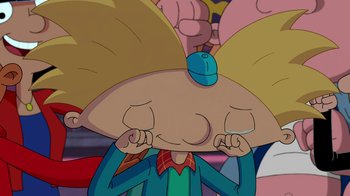 Movie still from “Hey Arnold: The Jungle Movie” (2017), directed by Raymie Muzquiz – A cartoon character with his eyes closed; Close Up shot, Overhead angle