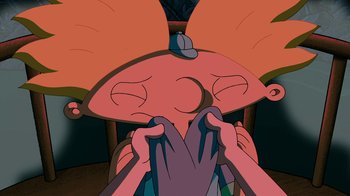 Movie still from “Hey Arnold: The Jungle Movie” (2017), directed by Raymie Muzquiz – A person holding their head in front of another person's face; Close Up shot, Overhead angle