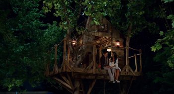 Movie still from “High School Musical 3: Senior Year” (2008), directed by Kenny Ortega – Two people sitting in a tree house at night; Wide shot, High angle