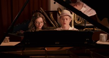 Movie still from “High School Musical 3: Senior Year” (2008), directed by Kenny Ortega – A boy and a girl are sitting at a piano; Medium shot, Over the shoulder angle